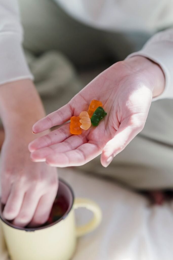 Crafting Captivating Headlines: Your awesome post title goes here From above of crop anonymous female holding handful of yummy colorful gummy bears and drinking hot coffee on cozy bed